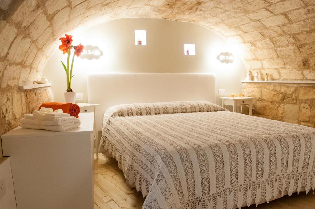 a bedroom with a bed in a brick wall at Murgia Dreams in Altamura