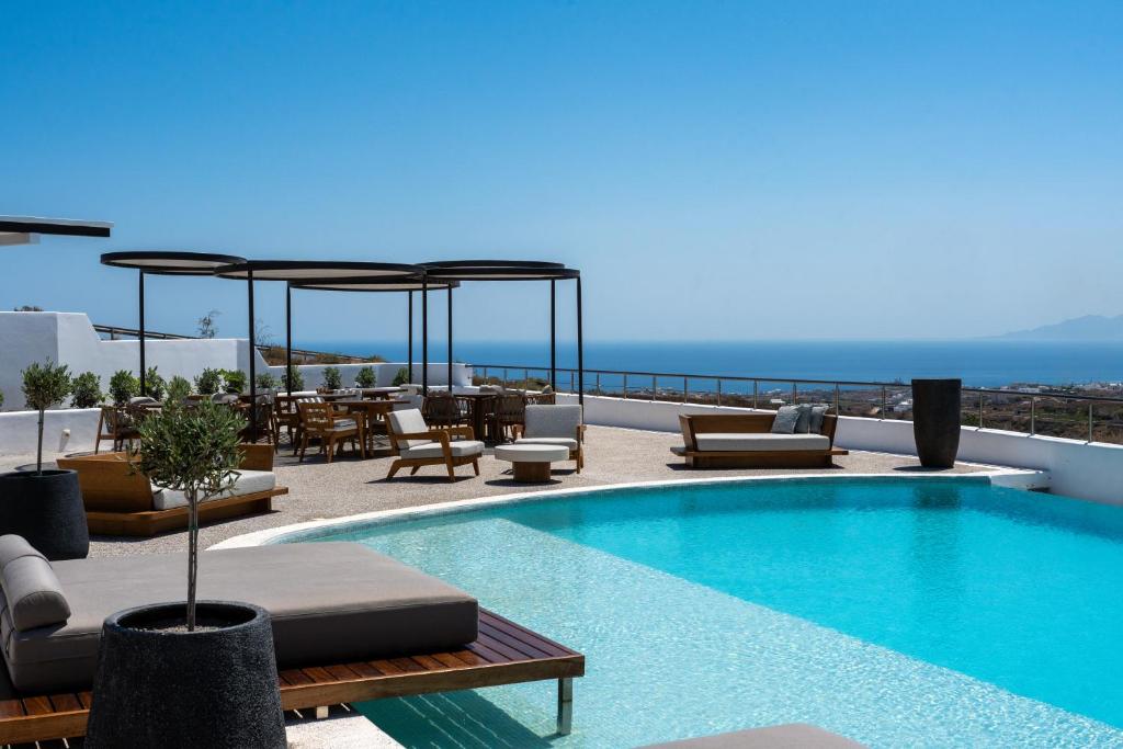a swimming pool on the roof of a building at Oikos Santorini Living Concept in Fira