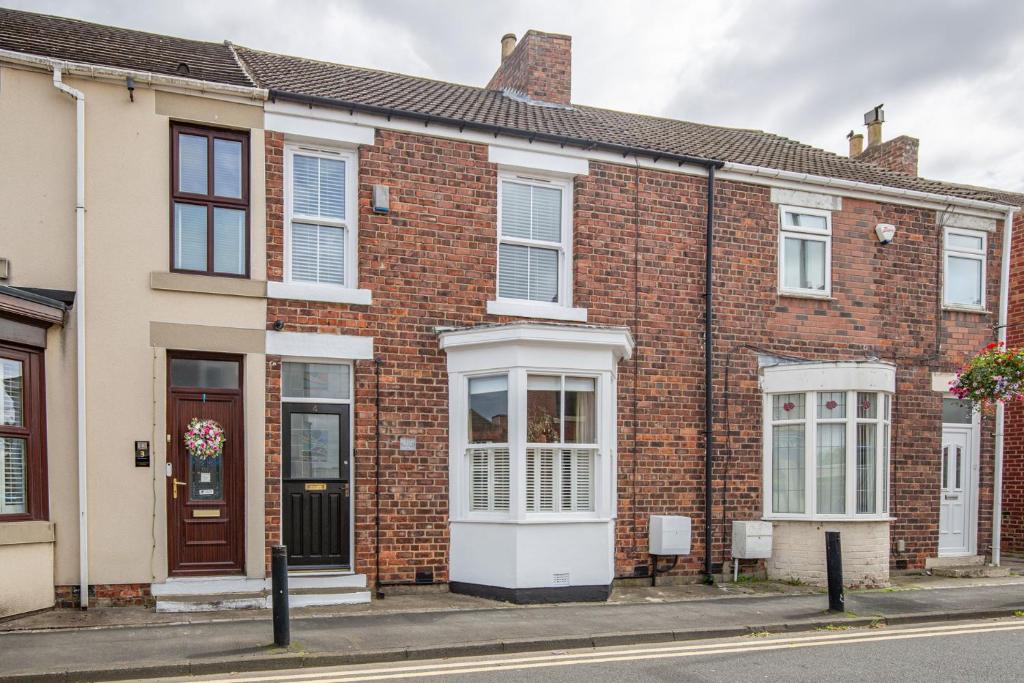 a row of brick houses on a street at Hudson House in Durham