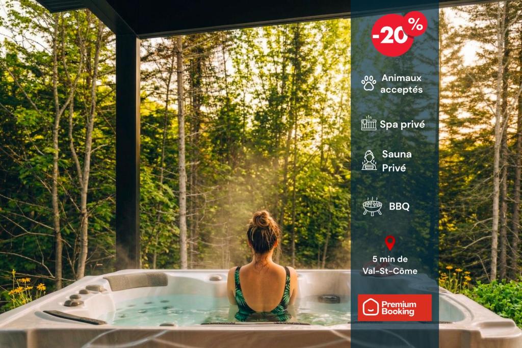 a woman sitting in a bath tub in the forest at Chalet Gratitude with Private SPA & Sauna in Saint Come