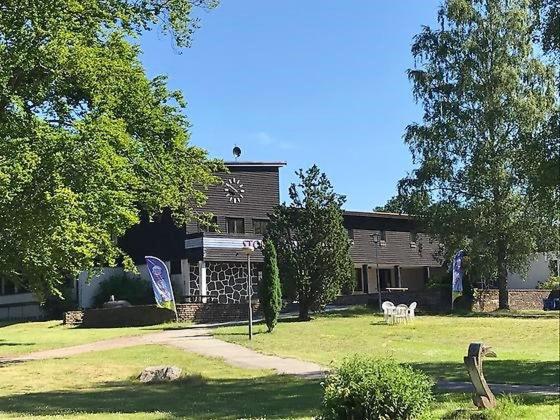 a house with a yard with a building at Frostavallen Hostel in Långstorp