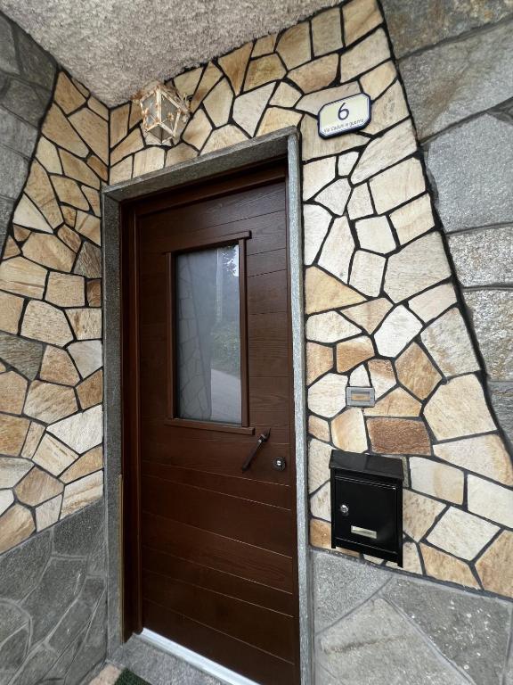 a door to a building with a stone wall at Casa Balzarini- Vecchio Mulino in Entracque