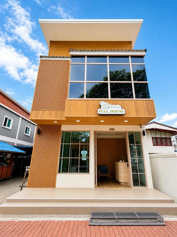 a building with a sign on the front of it at Full House Chiangkhan 21 in Chiang Khan