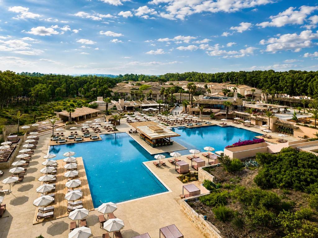 an aerial view of a resort with a pool and umbrellas at Mangia's Costa Ragusa Borgo - New Opening in Scoglitti