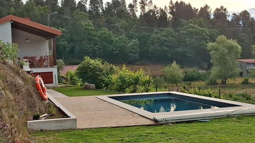 a swimming pool in the yard of a house at Quinta da Peça Douro Wine Region Retreat, Private Pool Villa in Vila Real