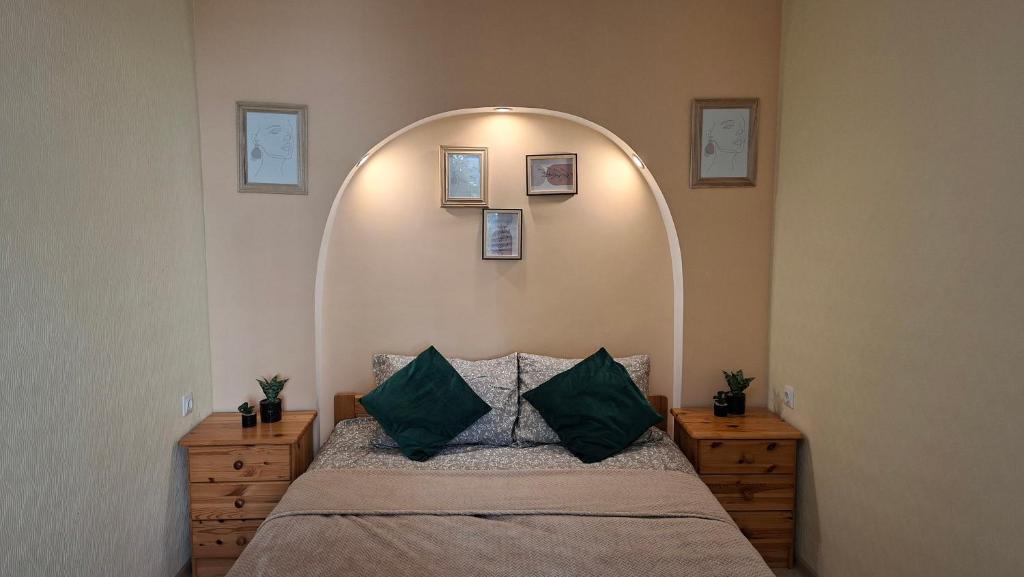 a bedroom with a large bed with an arch above it at Border Madise Apartment, Madise tn 8, Apt 7, Narva in Narva