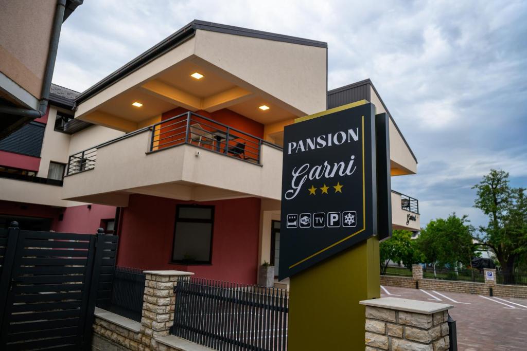 a restaurant sign in front of a house at Pansion Garni in Bihać
