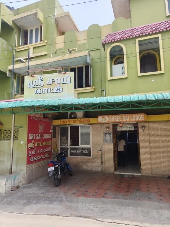 a motorcycle parked in front of a building at Sri Sai Lodge in Palni