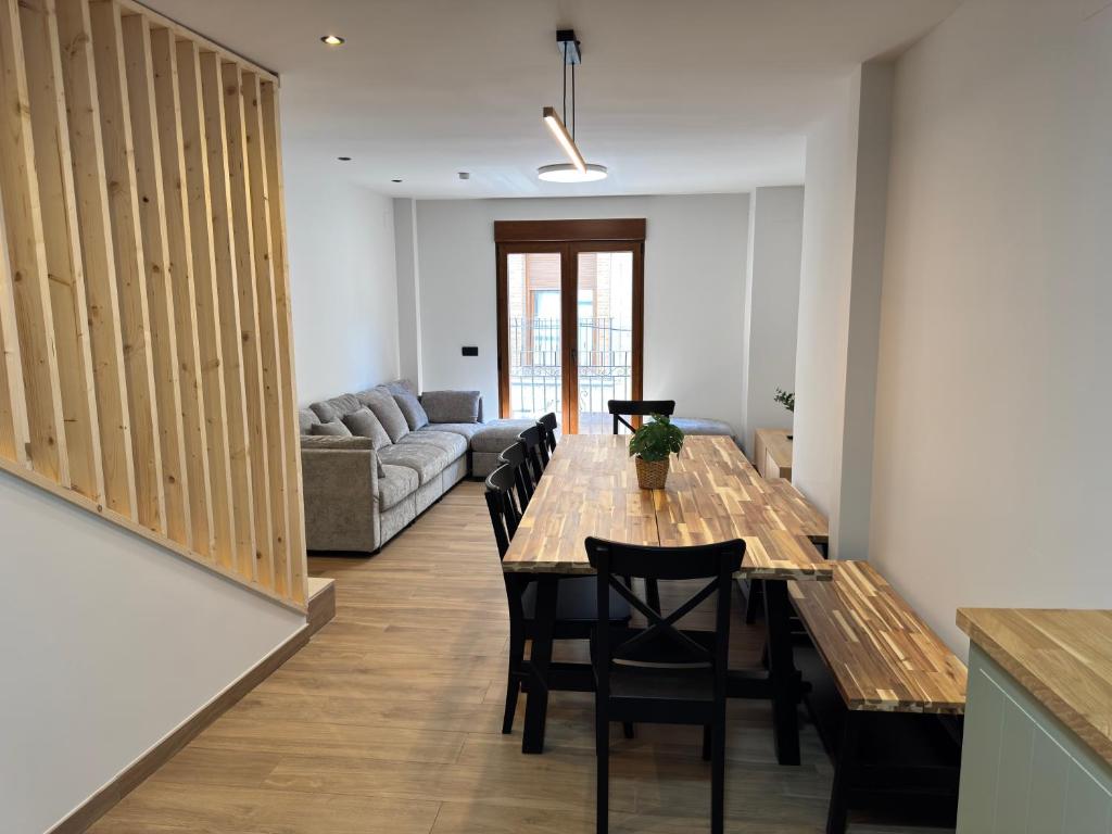 a living room with a table and chairs and a couch at Casa Ara Montanejos in Montanejos