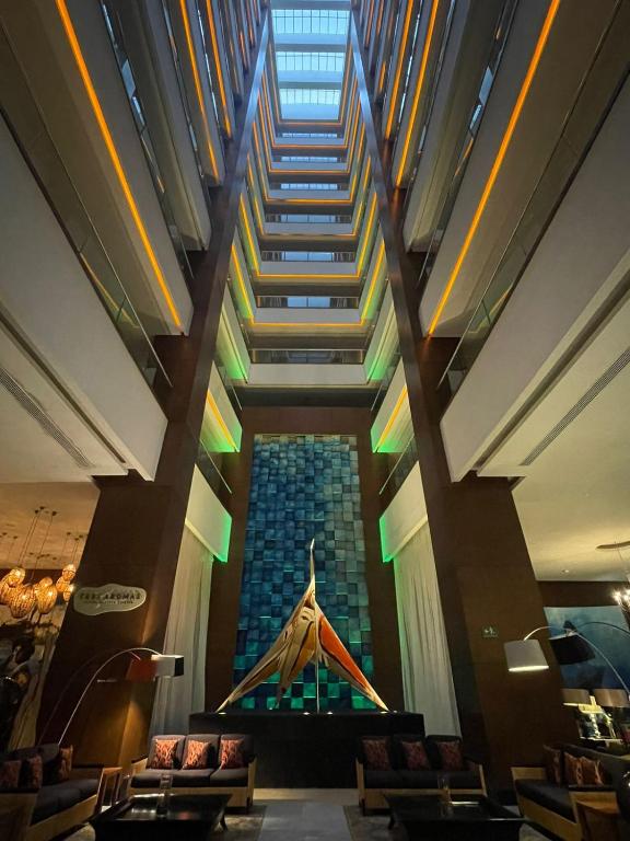 a staircase in the lobby of a building with chairs at 2 bedroom luxury apartment in Nuevo Nayarit