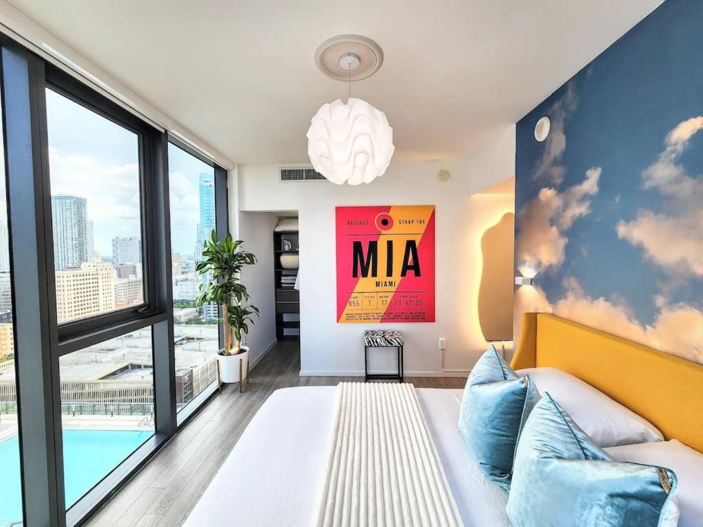 a living room with a couch and a large window at Electric Luxury Downtown Bayfront Brickell in Miami
