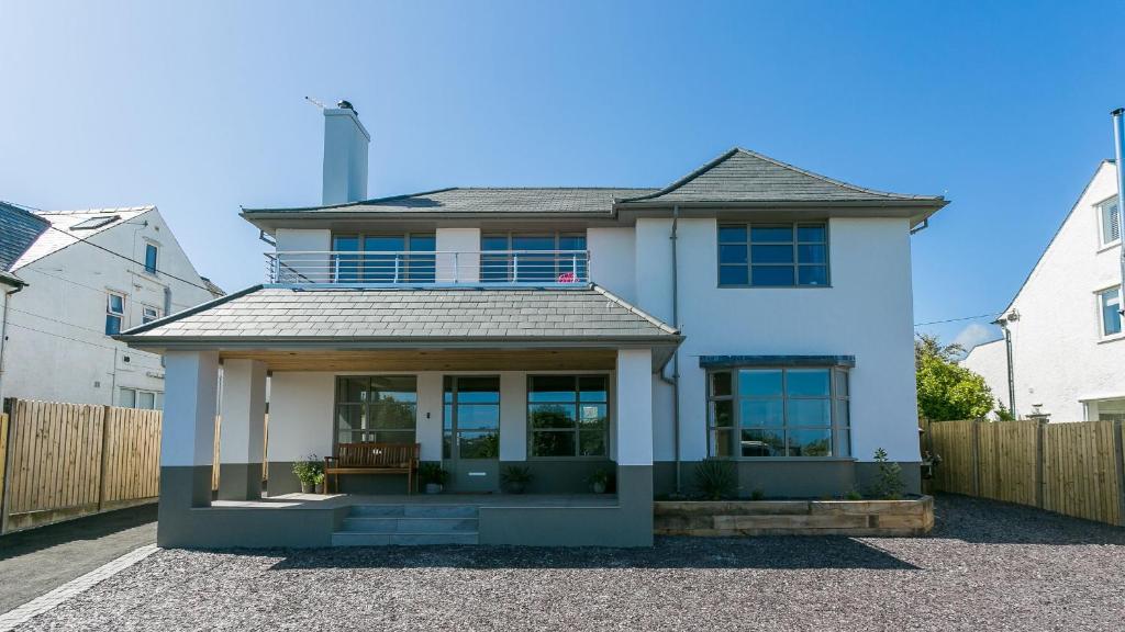 a white house with a lot of windows at Glangors in Abersoch