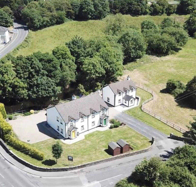 an aerial view of a house with a driveway at Riverbank Cottages in Scarriff