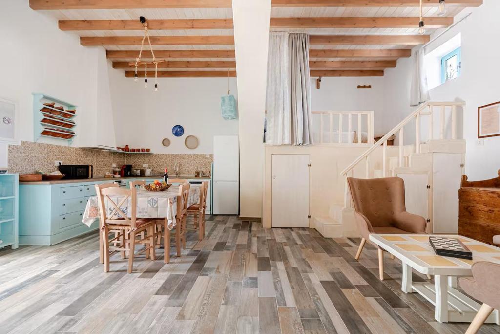 a kitchen and dining room with a table and chairs at Stefanis Relis House in Archangelos