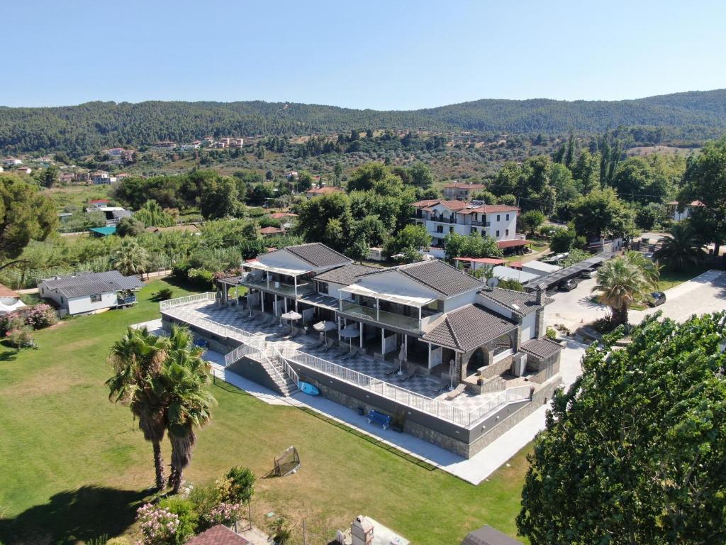 an aerial view of a large house with a yard at The Palms novasithonia in Vourvourou