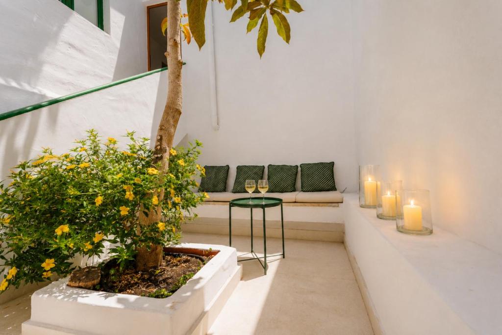 a room with a bench with candles and a plant at Avocado Corner House - Charco de San Gines By Lanzarote Vacation Homes in Arrecife