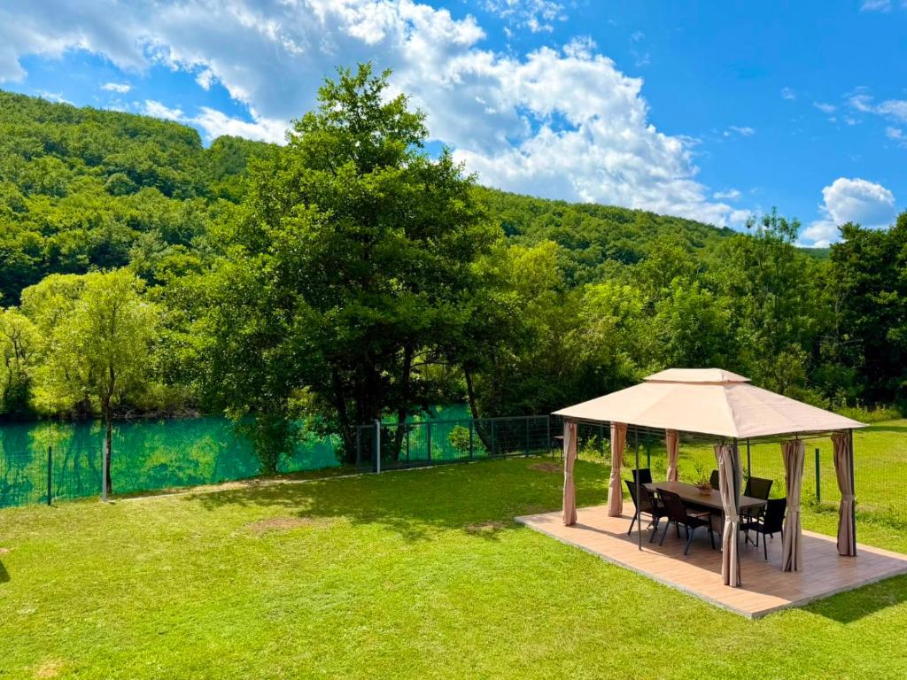 ein Pavillon mit Tisch und Stühlen im Gras in der Unterkunft Aquaverde in Orašac