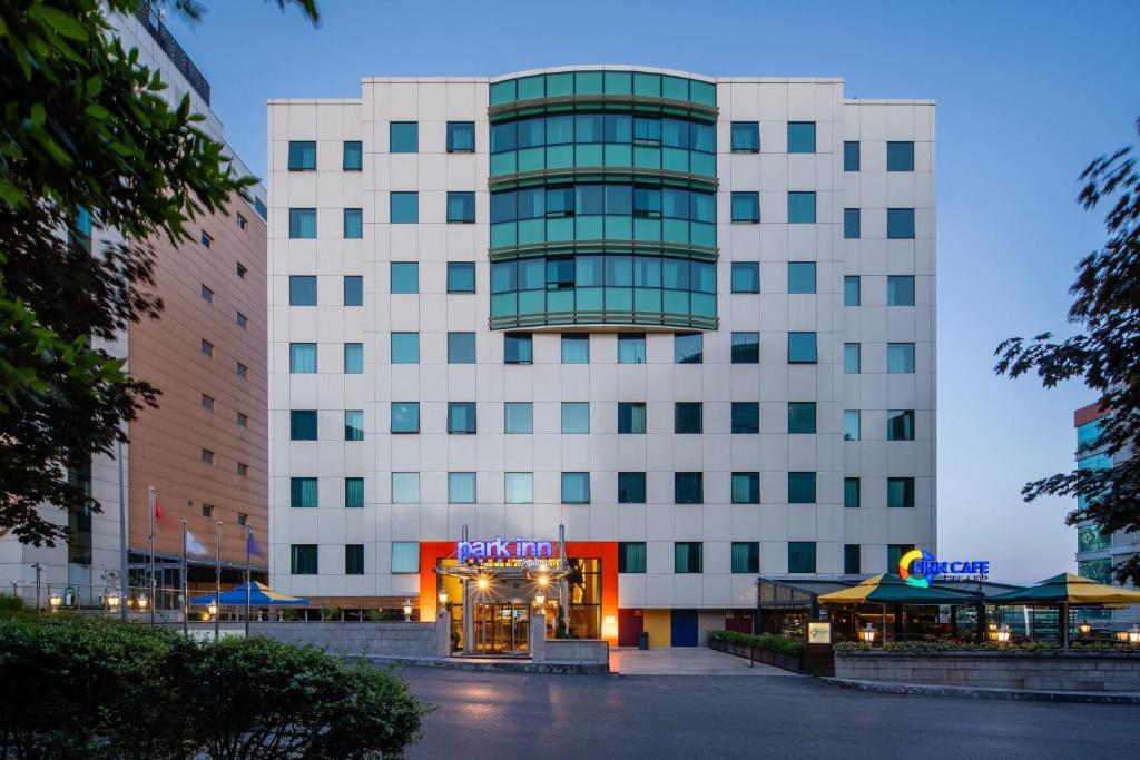 a large white building with a sign on it at Park Inn by Radisson Istanbul Asia Kavacik in Istanbul