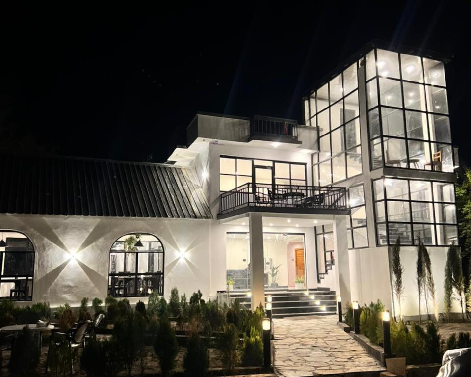 a large white house at night with lights at Hotel Desert Bloom Skardu in Skardu