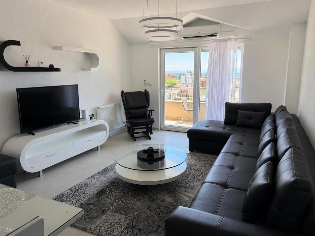 a living room with a couch and a tv at Serenity Apartment in Struga