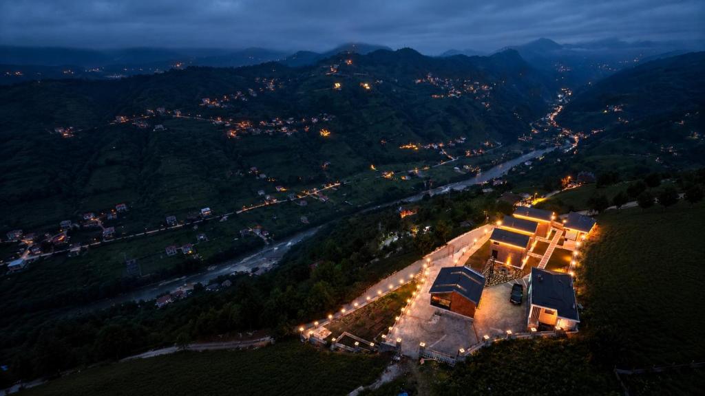 an aerial view of a building on a hill at night at Lazivilla Suit Dağ Evi in Rize