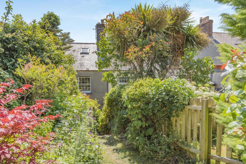 a garden in front of a house with a fence at 3 Bed in Bridport oc-dc160 in Bridport