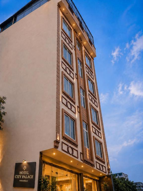 a tall building with a sign in front of it at Hotel City Palace in Varanasi