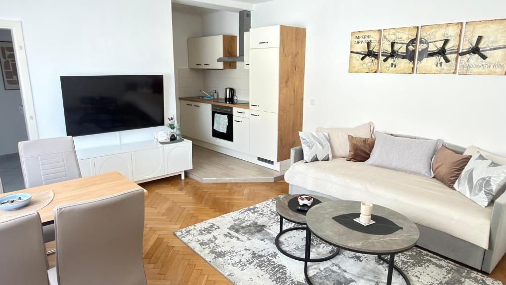 a living room with a couch and a table at Apartment Niki in Siegendorf im Burgenland