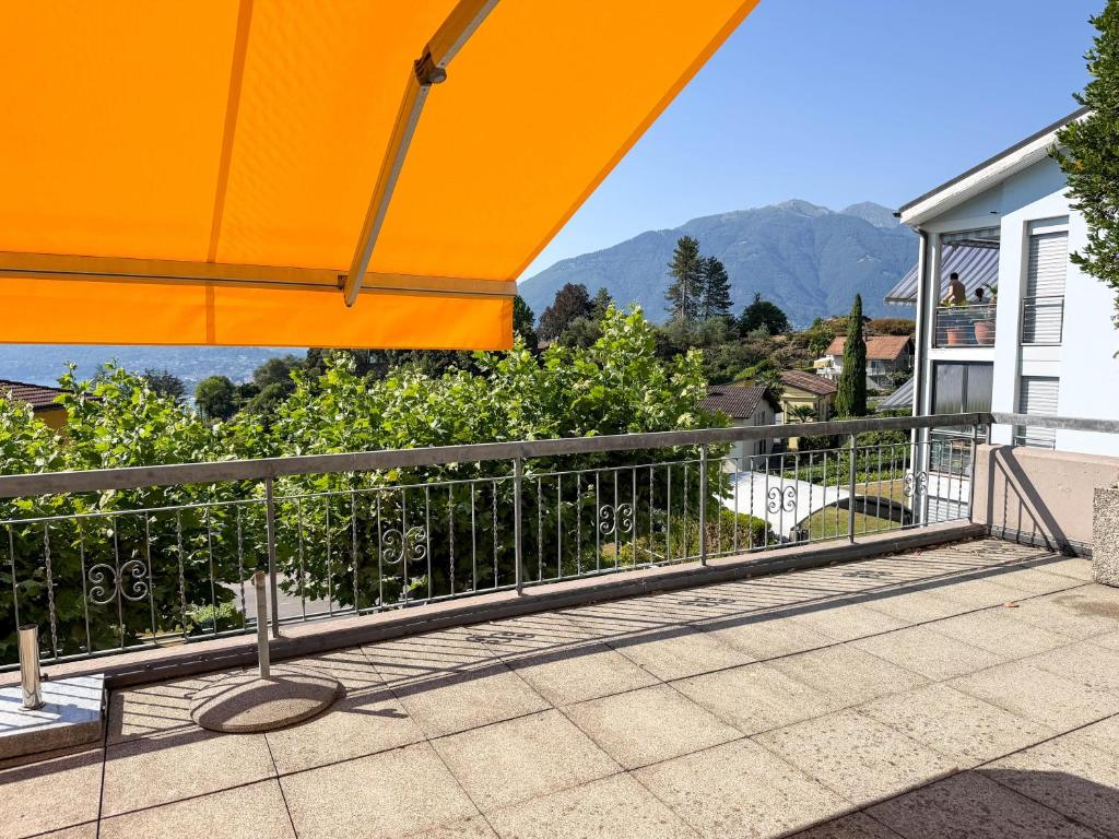 a view from the balcony of a house with an orange umbrella at Res Roncaccio, Cancro by HolAp SA in Vairano