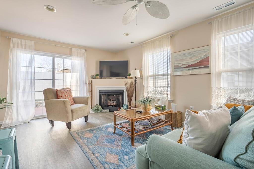 a living room with a couch and a fireplace at CoastalBoho-Spacious 4BDtownhouse 3 mi from beach in Rehoboth Beach