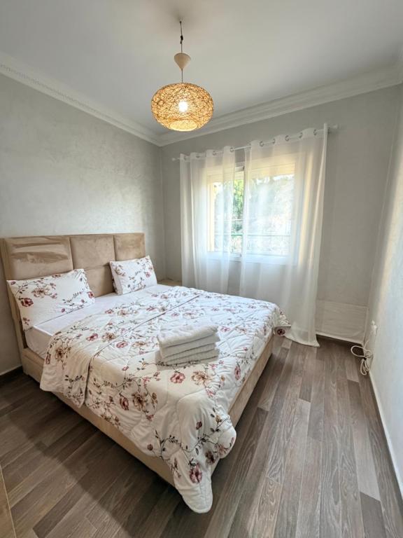 a bedroom with a bed and a window at casa jihan playa TGV in Tangier