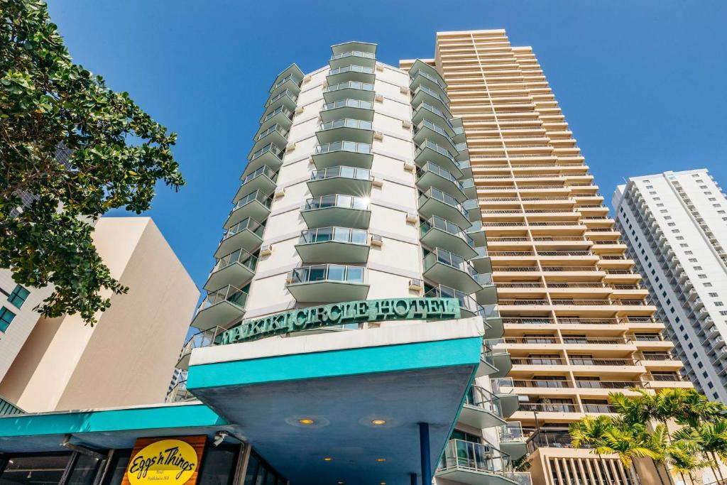 a tall apartment building with a sign on it at Waikiki Circle Hotel by Castle in Honolulu