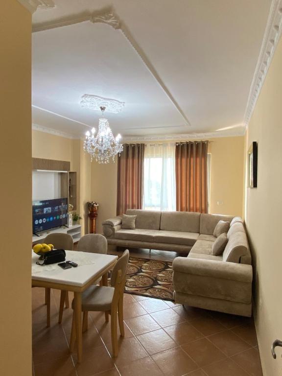 a living room with a couch and a table at Lushnja Apartament in Lushnjë