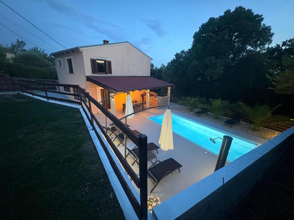 a house with a swimming pool next to a building at Kuca za odmor Adriatica in Antovo