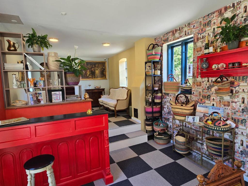 a shop with a red counter and a checkered floor at Solvang in Assens