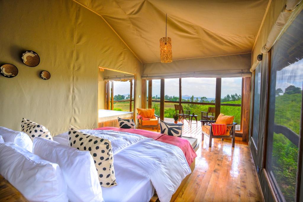 a bedroom with a bed in a tent at Rhotia Valley Tented camp in Karatu