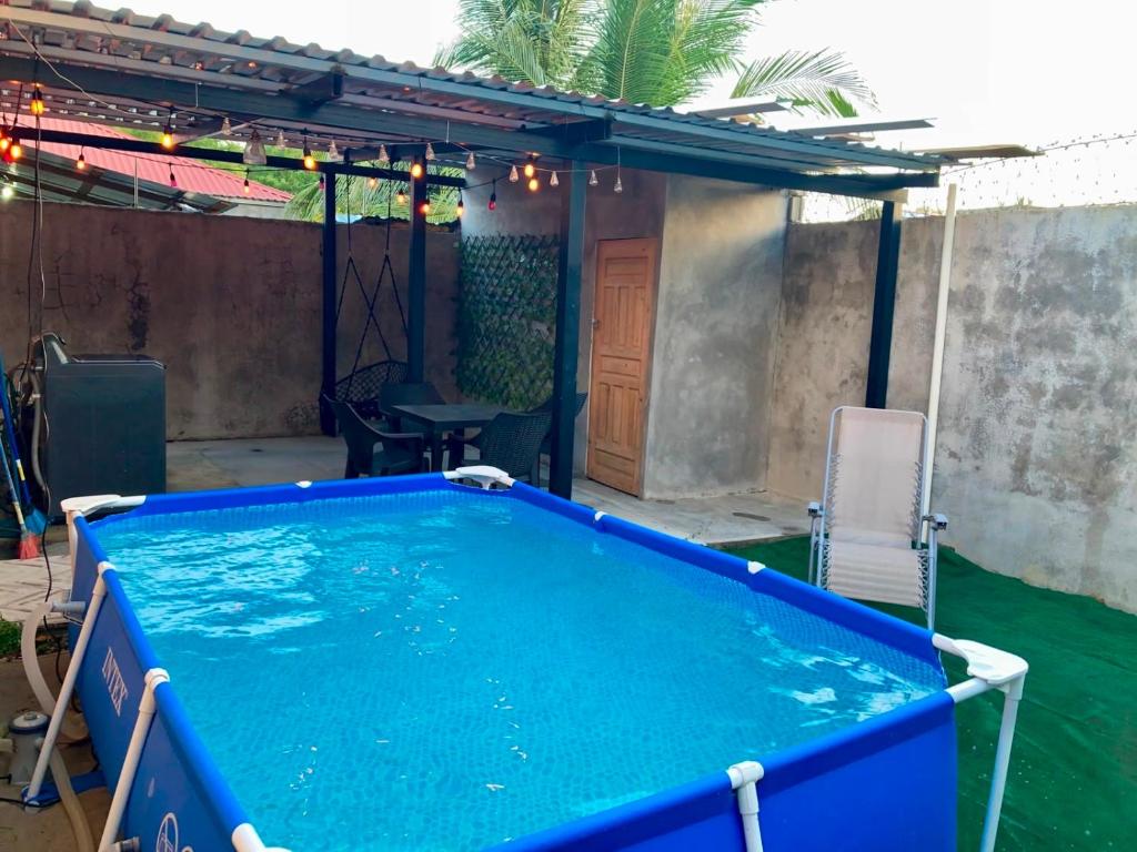a swimming pool in a backyard with a pergola at Joy & peace house in Tela
