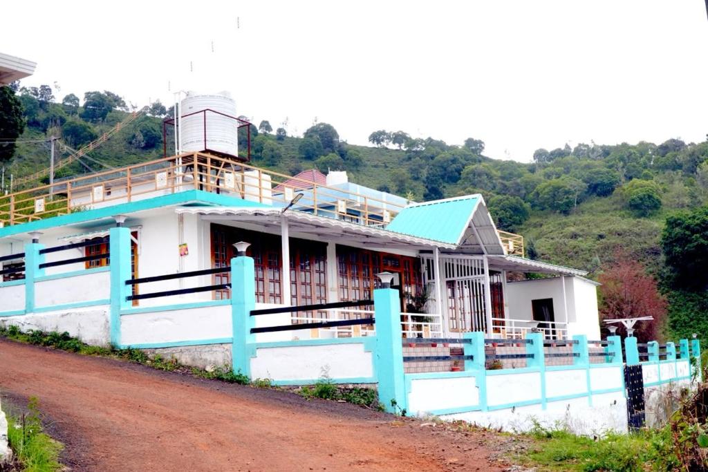 a house on the side of a dirt road at Arupa Homestay in Ooty