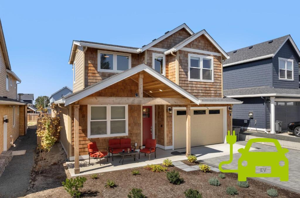 a house with a garage in a yard at Red Door MCA#50500 in Manzanita
