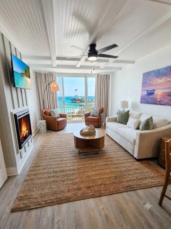 a living room with a couch and a fireplace at Lavish Coastal Oceanfront Suite Yachtsman 401 in Myrtle Beach