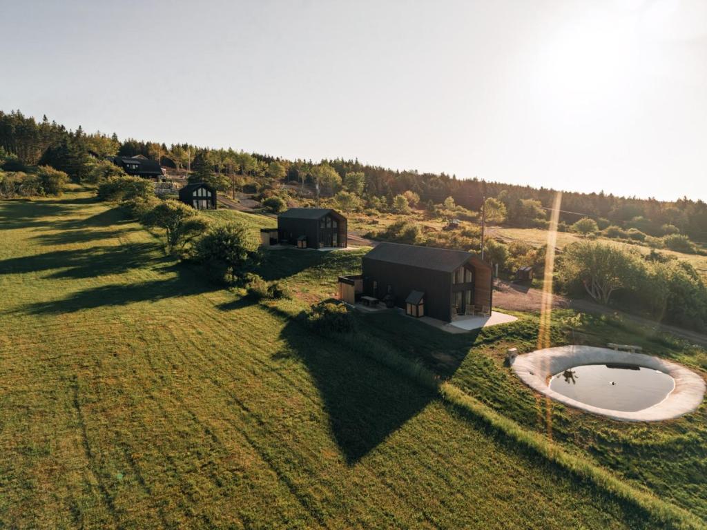 an overhead view of a house in a field with a pond at Modern Nordic Cabin 1 w/ Hot Tub & Views in East LaHave