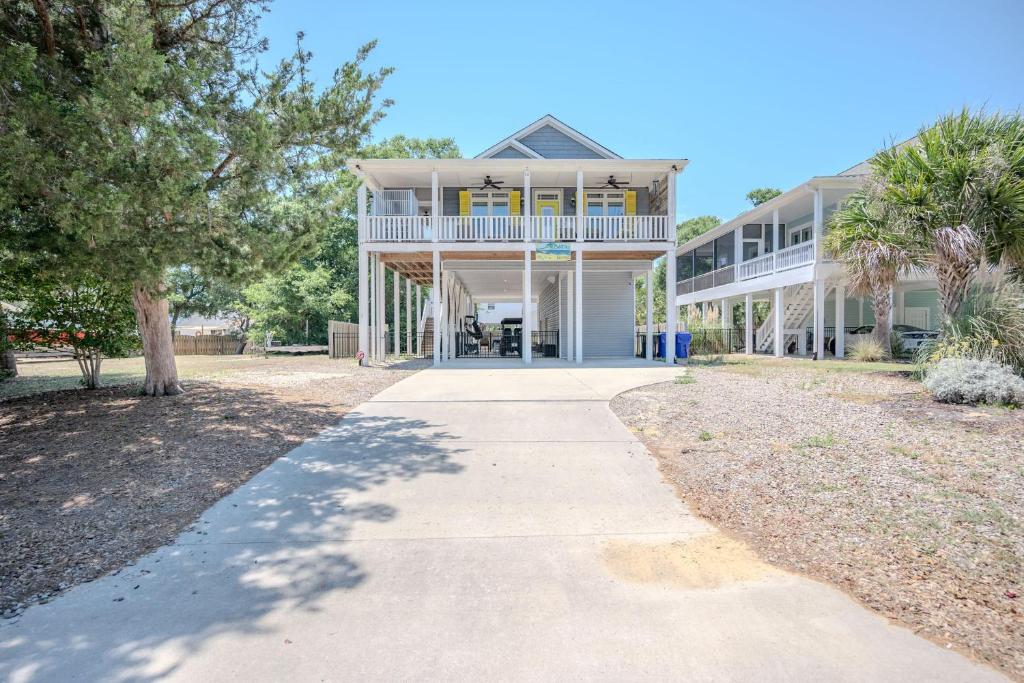 a large white building with a walkway in front of it at Chateau Relaxo by Oak Island Accommodations in Oak Island