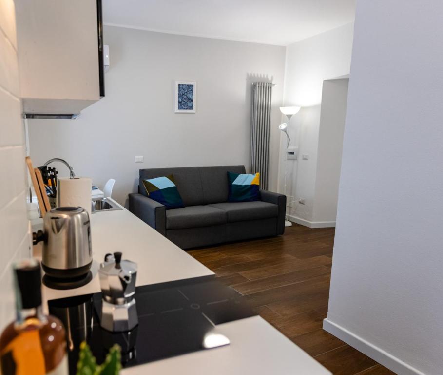 a kitchen and a living room with a couch at Casa Frino in Ghiffa