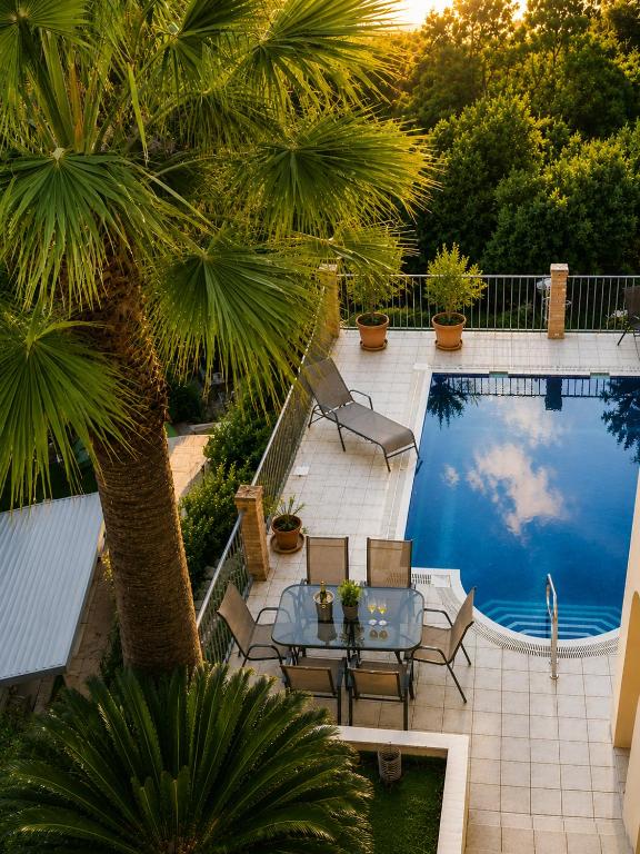 a patio with a table and chairs next to a swimming pool at Mijas Villa Doña Pilar Pool & Jacuzzi in Mijas