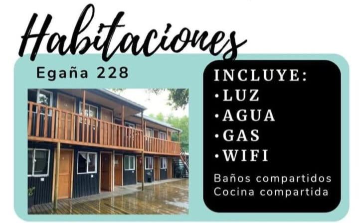 a sign for an apartment building in the rain at Hostal Egaña 228 in Puerto Montt
