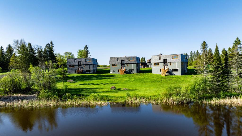 a group of houses on a hill next to a lake at Snowriver Mountain Resort in Wakefield
