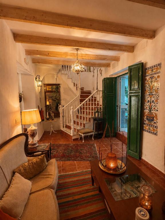 a living room with a couch and a table at Encanto Guesthouse in Canillas de Aceituno