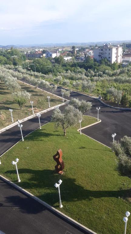 a statue of a bear sitting in a grass field at Agroturizem Prelude in (( Barç ))