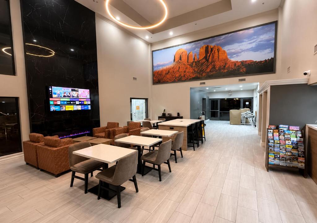 a restaurant with tables and chairs and a tv on the wall at Quality Inn Casa Grande I-10 in Casa Grande