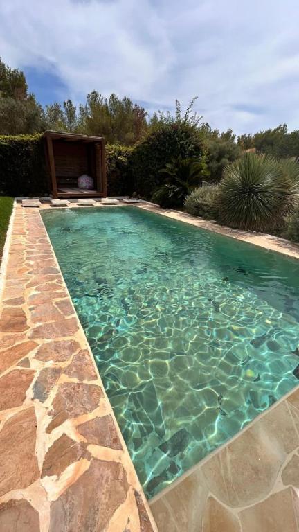 a swimming pool with turquoise water in a yard at SERENITY pool Ibiza Villa in Santa Eularia des Riu
